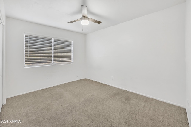 spare room featuring ceiling fan and carpet floors