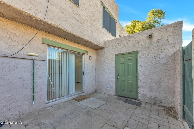 property entrance featuring a patio area