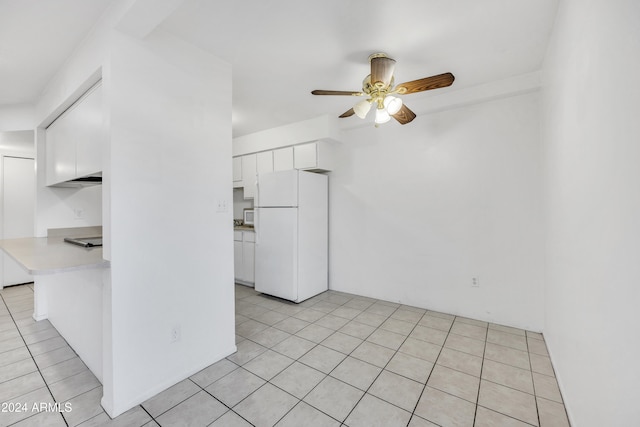 kitchen featuring ceiling fan, white cabinets, light tile patterned floors, and white refrigerator