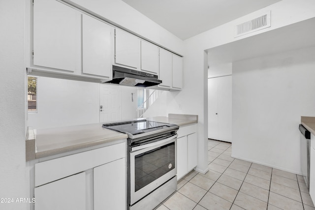 kitchen with white cabinets, light tile patterned flooring, stainless steel appliances, and a wealth of natural light