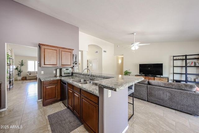 4558 E Libby St, Phoenix, AZ 85032 - kitchen with dishwasher, a sink, ceiling fan, open floor plan, and a kitchen breakfast bar