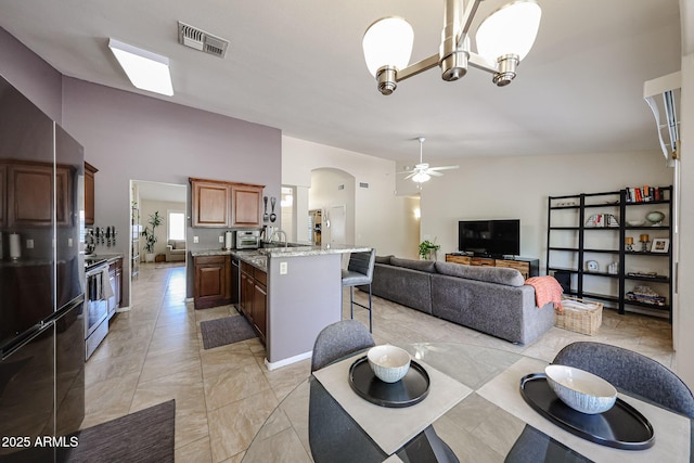 4558 E Libby St, Phoenix, AZ 85032 - dining space featuring ceiling fan, arched walkways, and a chandelier