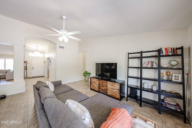 4558 E Libby St, Phoenix, AZ 85032 - living room featuring a ceiling fan, vaulted ceiling, and arched walkways