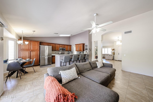4558 E Libby St, Phoenix, AZ 85032 - living room with plenty of natural light, ceiling fan, arched walkways, high vaulted ceiling, and baseboards