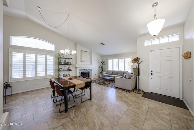 4558 E Libby St, Phoenix, AZ 85032 - dining room with a fireplace, high vaulted ceiling, baseboards, and a chandelier
