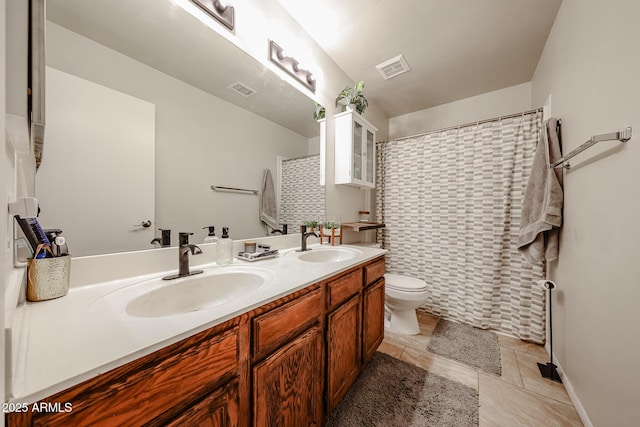 4558 E Libby St, Phoenix, AZ 85032 - bathroom featuring toilet, double vanity, and tile patterned flooring