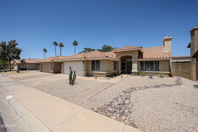 4558 E Libby St, Phoenix, AZ 85032 - mediterranean / spanish home featuring stucco siding, an attached garage, concrete driveway, and a tiled roof