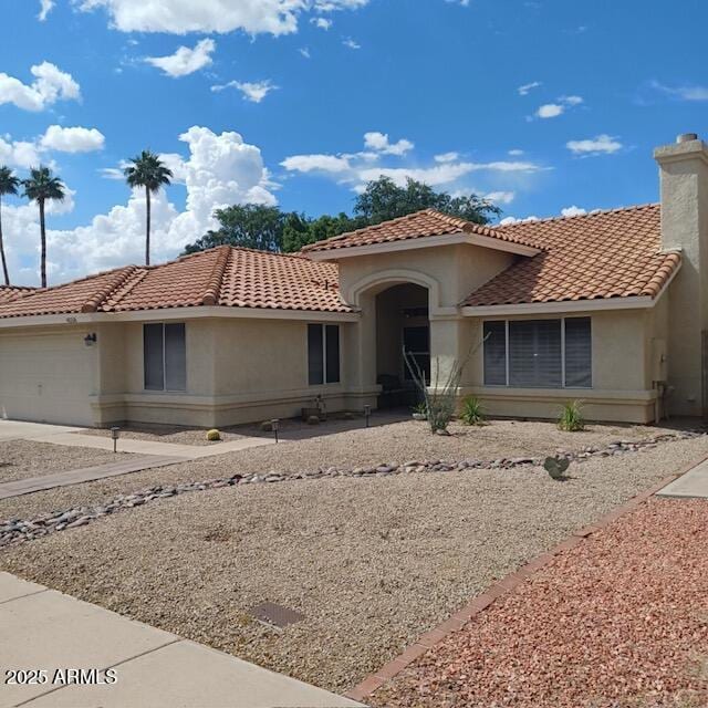 4558 E Libby St, Phoenix, AZ 85032 - mediterranean / spanish-style house featuring stucco siding, a tile roof, an attached garage, and concrete driveway