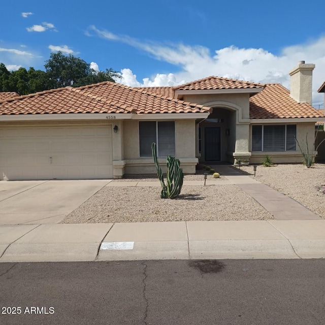 4558 E Libby St, Phoenix, AZ 85032 - mediterranean / spanish-style house with stucco siding, a garage, and a tile roof