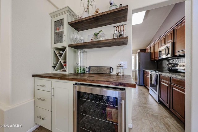 4558 E Libby St, Phoenix, AZ 85032 - indoor dry bar featuring wine cooler, appliances with stainless steel finishes, lofted ceiling, and decorative backsplash