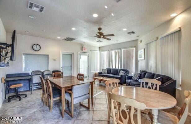 tiled dining area featuring ceiling fan