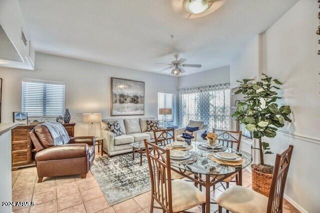 tiled dining area featuring ceiling fan