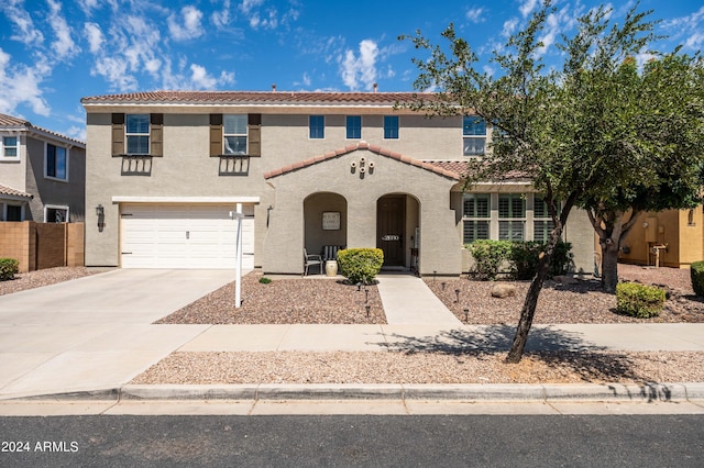 view of front of house featuring stucco siding, driveway, fence, an attached garage, and a tiled roof