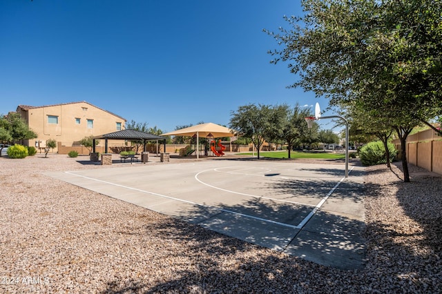 view of sport court featuring a gazebo, playground community, community basketball court, and fence