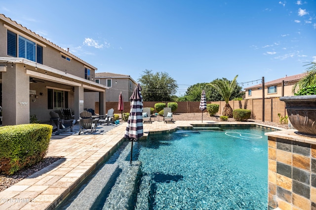 view of swimming pool with a patio area, a fenced in pool, a ceiling fan, and a fenced backyard