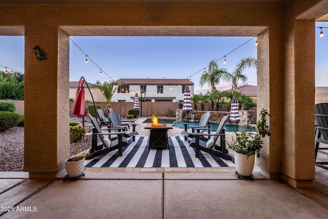 view of patio featuring a fenced backyard and an outdoor fire pit