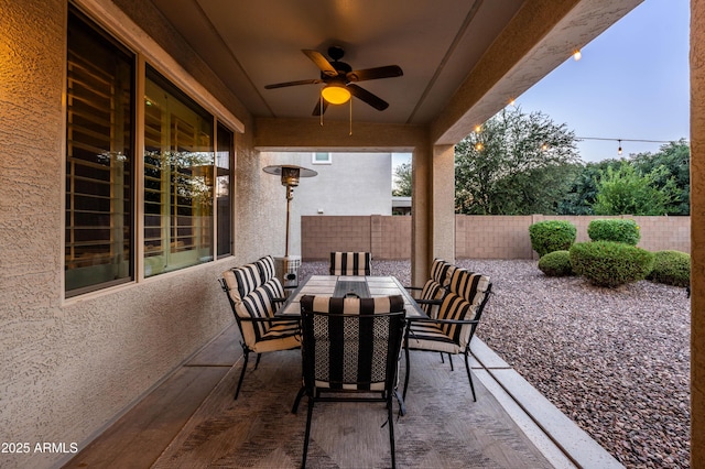 view of patio / terrace featuring a fenced backyard, outdoor dining area, and ceiling fan