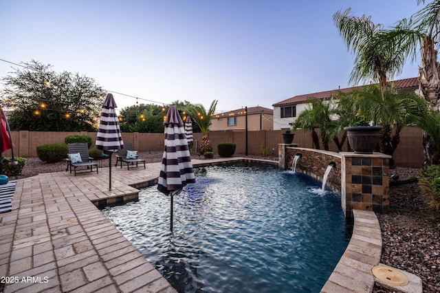 view of pool with a fenced in pool, a fenced backyard, and a patio area