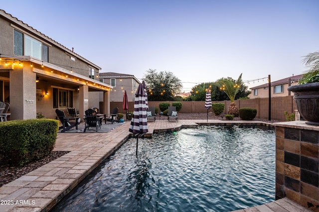 view of pool featuring a patio, a fenced backyard, and a fenced in pool