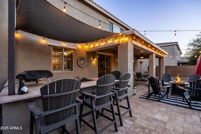 view of patio / terrace featuring outdoor dining space, a fire pit, and fence