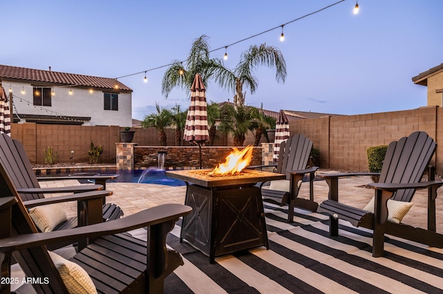 view of patio with a fenced backyard and an outdoor fire pit