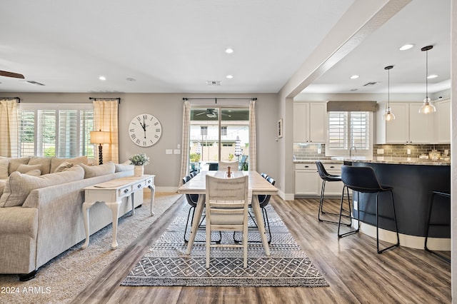 dining area with visible vents, baseboards, a ceiling fan, and light wood finished floors