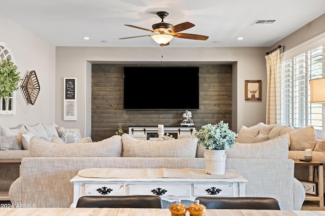 living area with recessed lighting, plenty of natural light, and ceiling fan