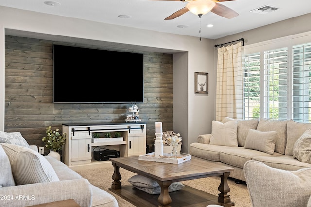 living area with visible vents, recessed lighting, wood walls, a fireplace, and ceiling fan