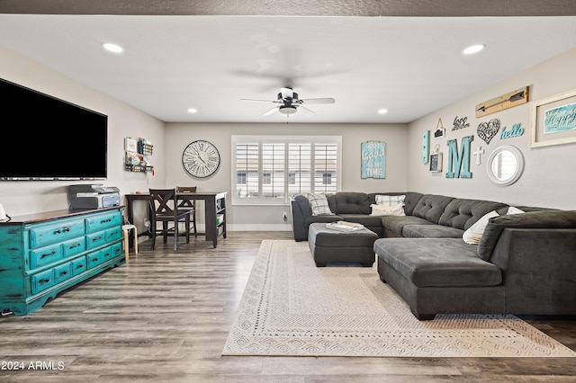 living area with a ceiling fan, recessed lighting, wood finished floors, and baseboards