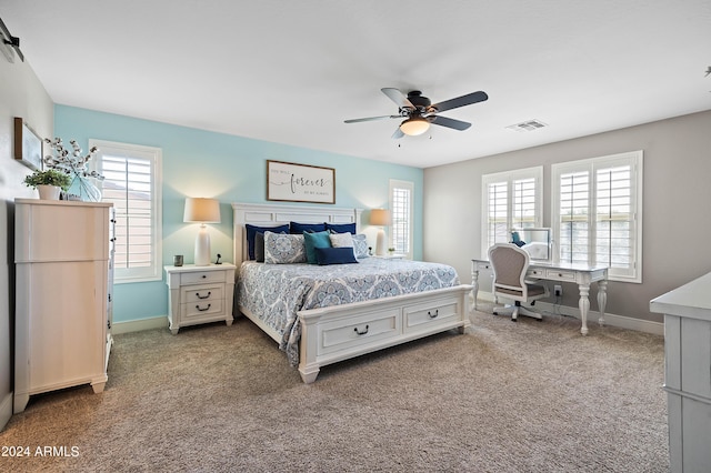 bedroom with multiple windows, baseboards, visible vents, and carpet floors