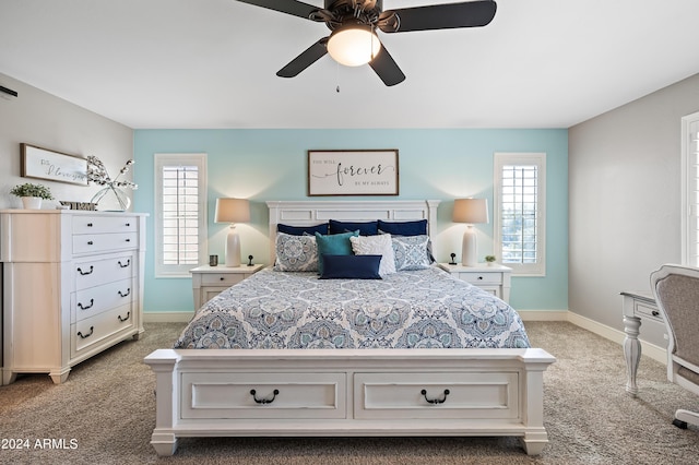 bedroom featuring baseboards, multiple windows, and carpet floors