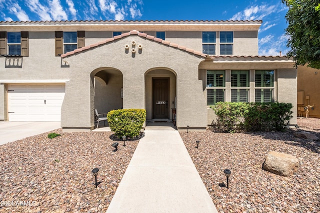 view of front of home featuring stucco siding, driveway, and a garage