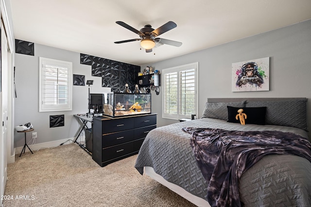 bedroom with baseboards, light carpet, and ceiling fan