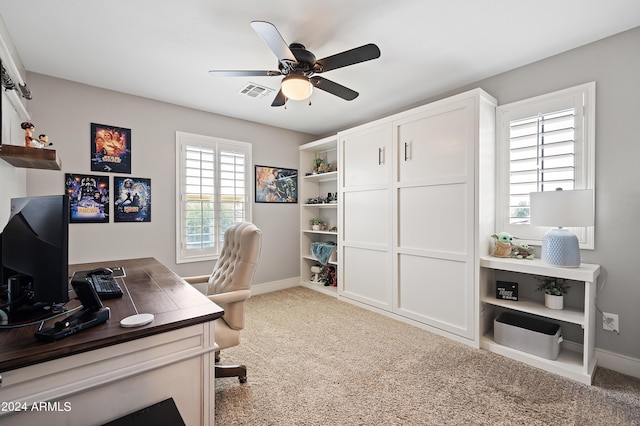 office with baseboards, visible vents, carpet floors, and ceiling fan