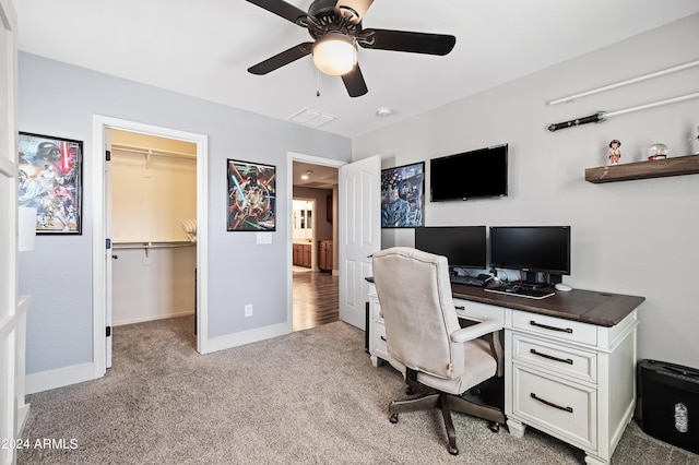 carpeted office with visible vents, ceiling fan, and baseboards