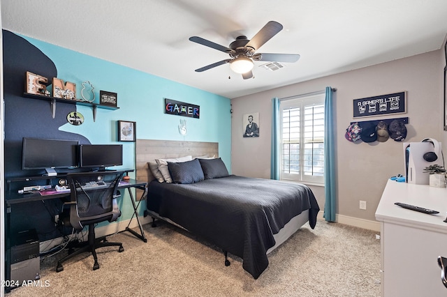 bedroom with visible vents, light colored carpet, baseboards, and a ceiling fan