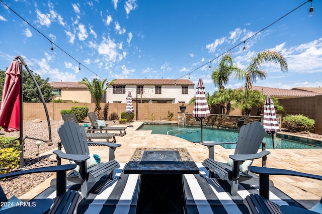 view of pool featuring a patio, a fire pit, a fenced in pool, and a fenced backyard