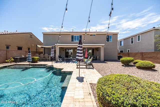 rear view of house featuring stucco siding, central AC, a fenced backyard, and a patio area