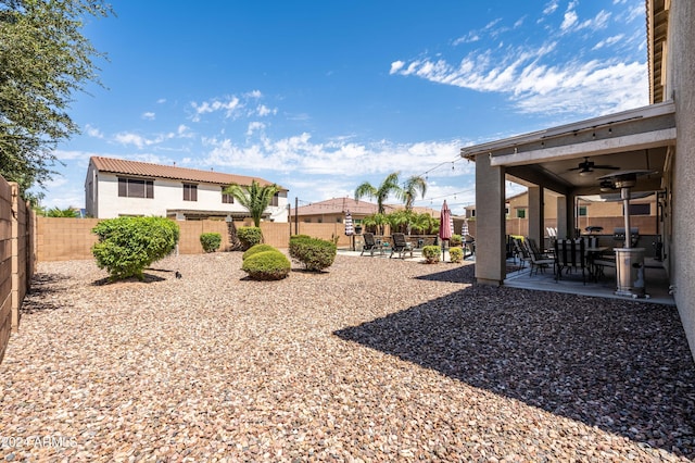 view of yard with a patio, a ceiling fan, and a fenced backyard