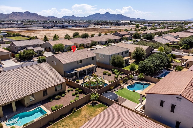 birds eye view of property with a mountain view and a residential view