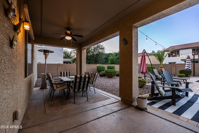 view of patio featuring a fenced backyard, outdoor dining space, and a ceiling fan