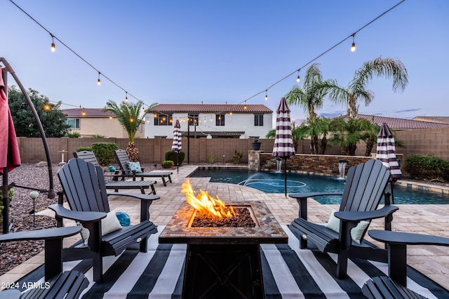 view of swimming pool with a patio, a fenced backyard, a fenced in pool, and an outdoor fire pit