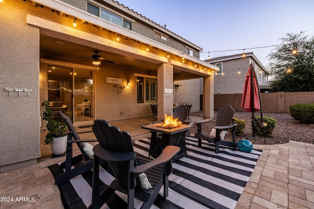 view of patio / terrace featuring ceiling fan, fence, and an outdoor fire pit