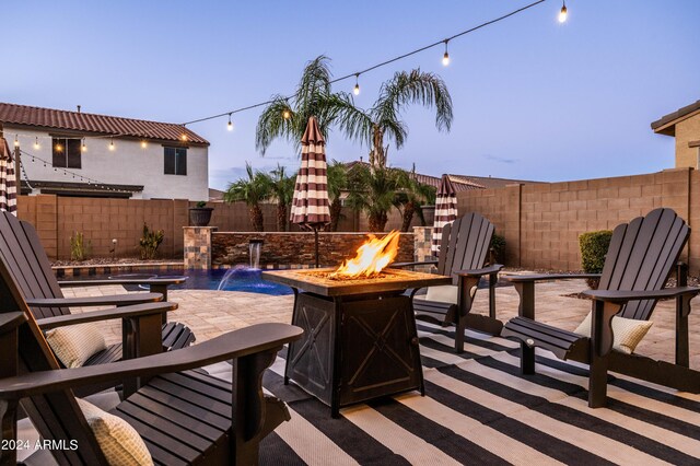 view of patio with a fenced backyard and an outdoor fire pit