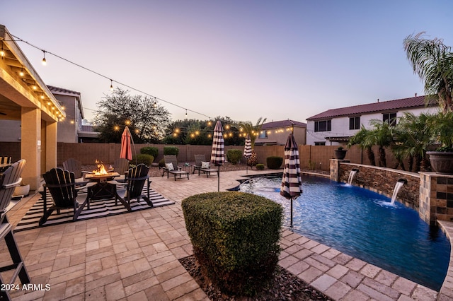 view of swimming pool featuring a fenced in pool, a patio, a fire pit, and a fenced backyard