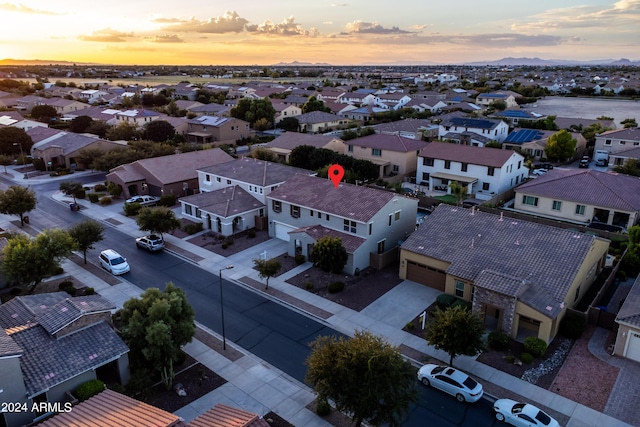 aerial view at dusk featuring a residential view