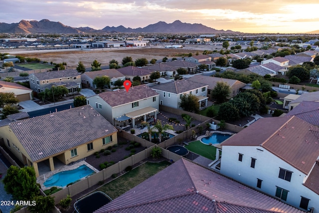 aerial view at dusk with a mountain view and a residential view