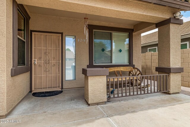 8214 S 48th Dr, Laveen, AZ 85339 - view of exterior entry with covered porch and stucco siding