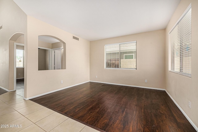 8214 S 48th Dr, Laveen, AZ 85339 - unfurnished room featuring healthy amount of natural light, baseboards, and wood finished floors