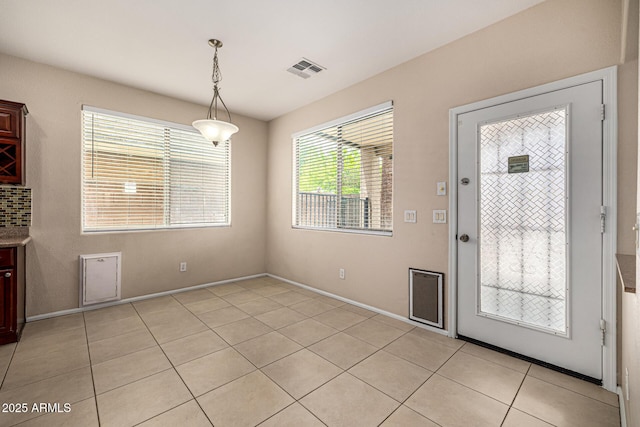 8214 S 48th Dr, Laveen, AZ 85339 - unfurnished dining area featuring light tile patterned floors and baseboards
